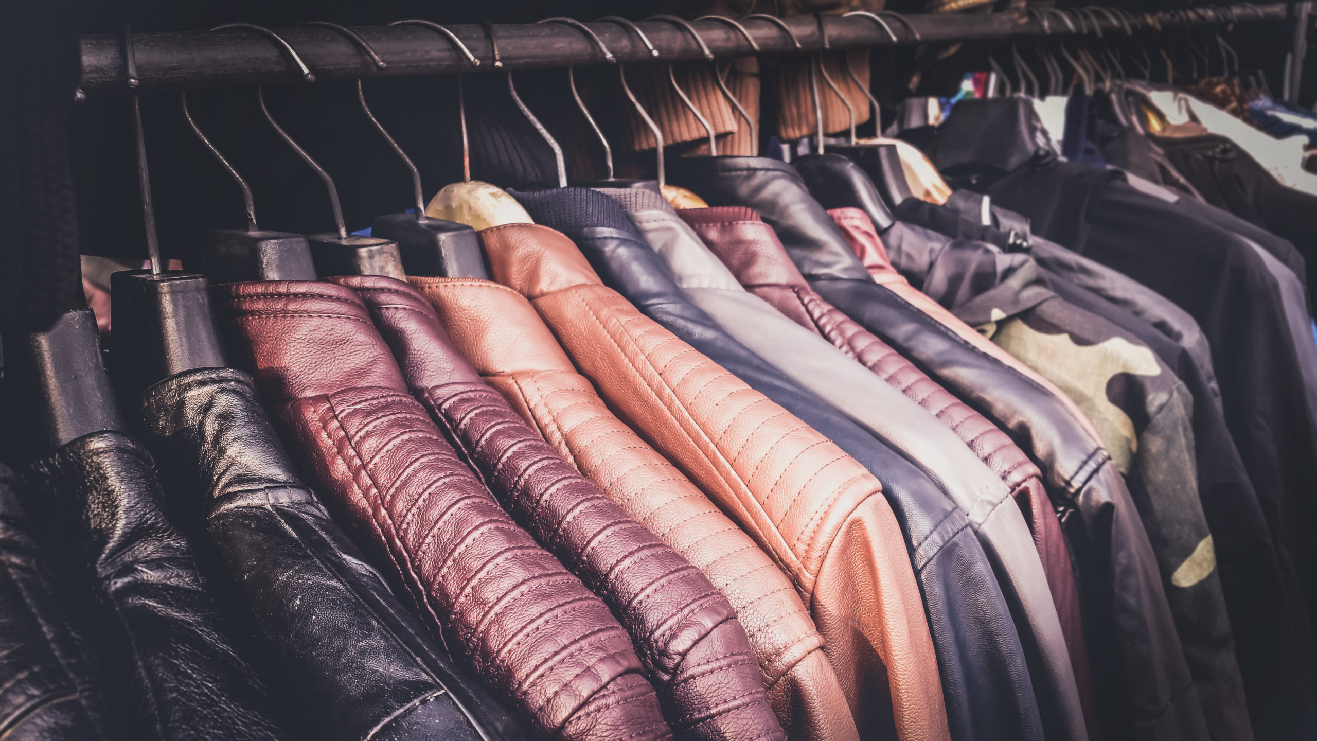 Collection of leather jackets on hangers in the shop for biker’s or