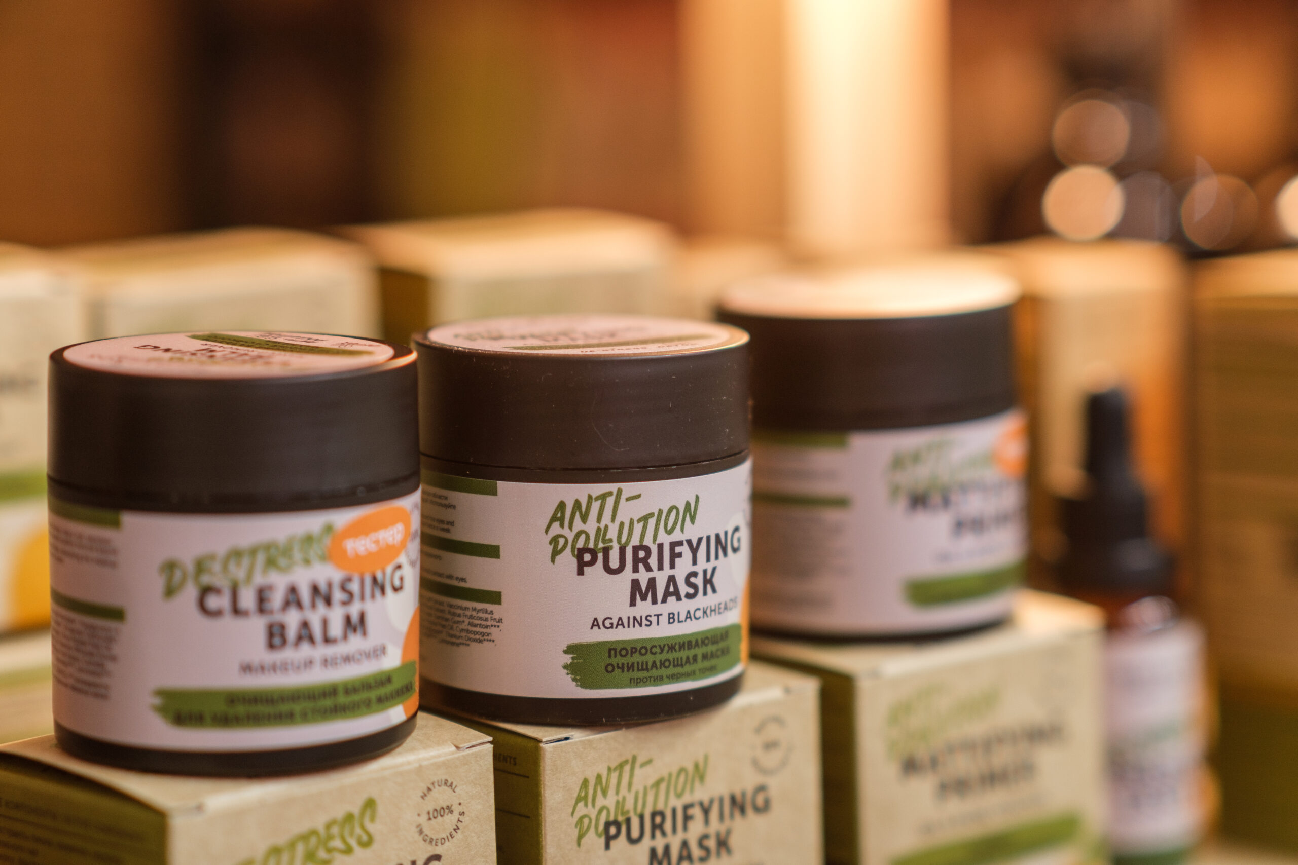 Shelves filled with various skin care products showcasing cleansing and purifying balms in a cozy wellness shop setting.