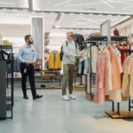 Customers Shopping in Modern Clothing Store