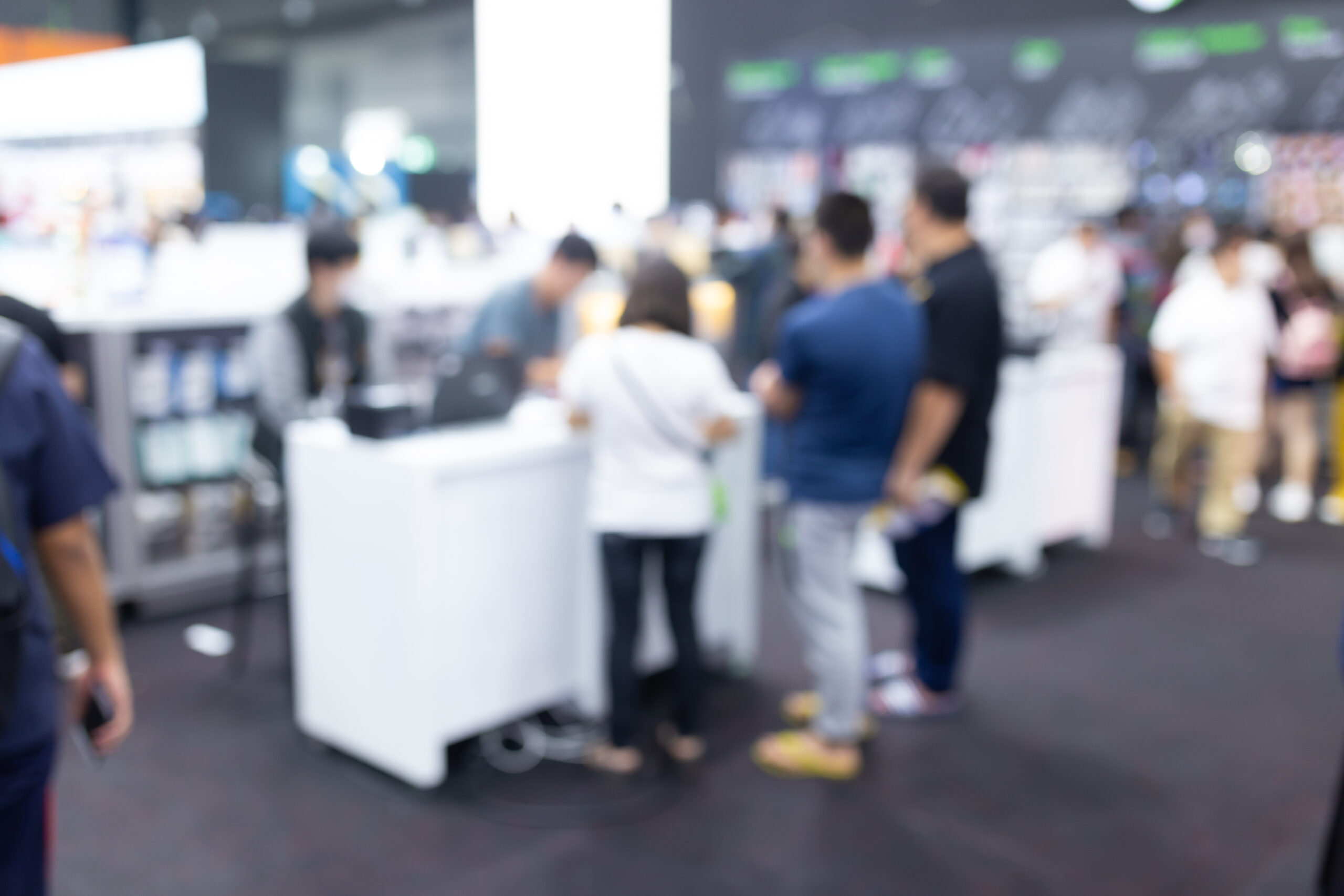 Abstract blur people in exhibition hall event trade show expo background.