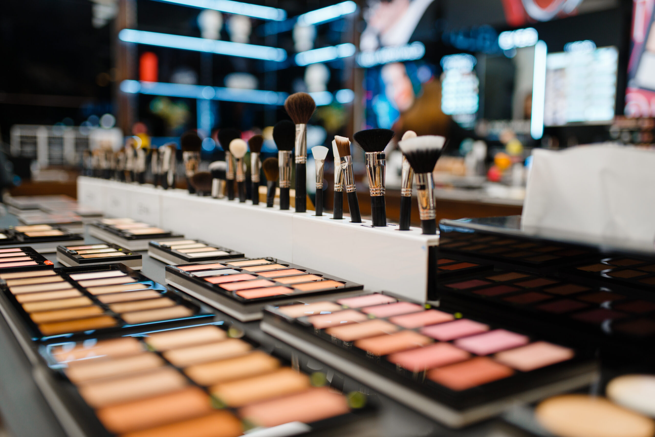 Showcase with powder and shadows in cosmetics store