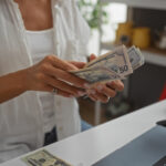 Woman handling cash while standing in a home decor store