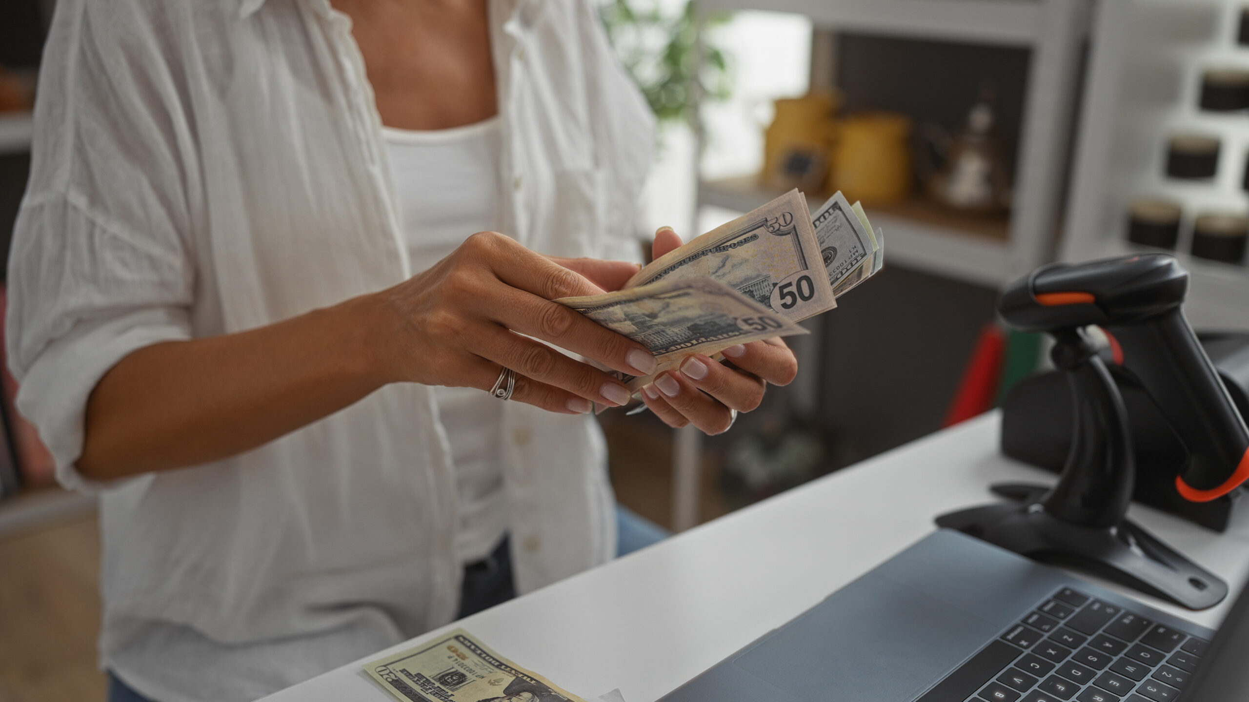 Woman handling cash while standing in a home decor store