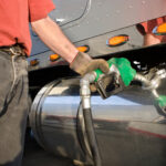 Man fueling Up a Freight Transport Truck