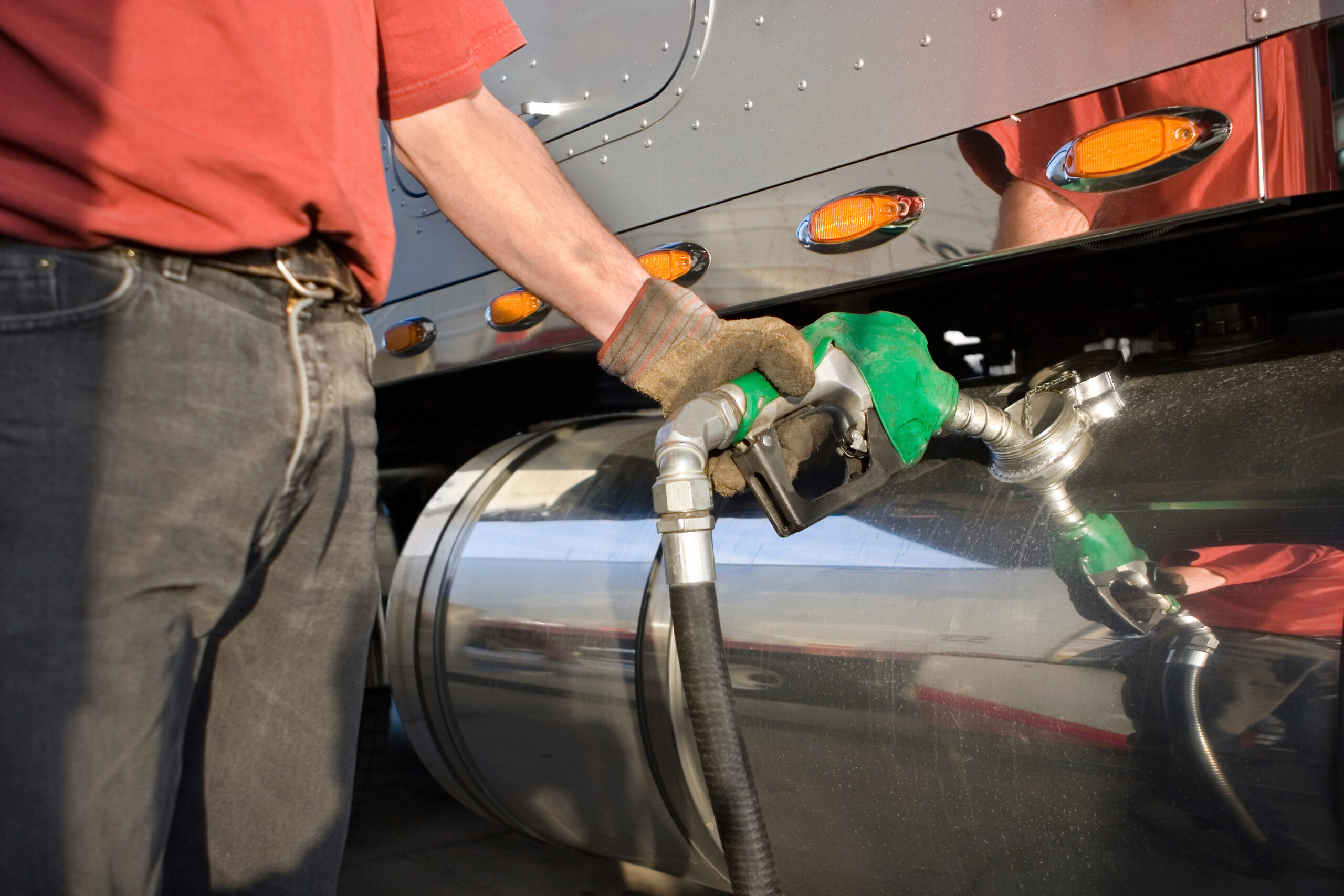 Man fueling Up a Freight Transport Truck