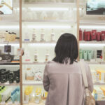 Woman standing in front of a shelf with skincare products of the South Korean brand
