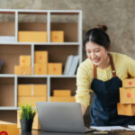 young female owner startup business work happy with box