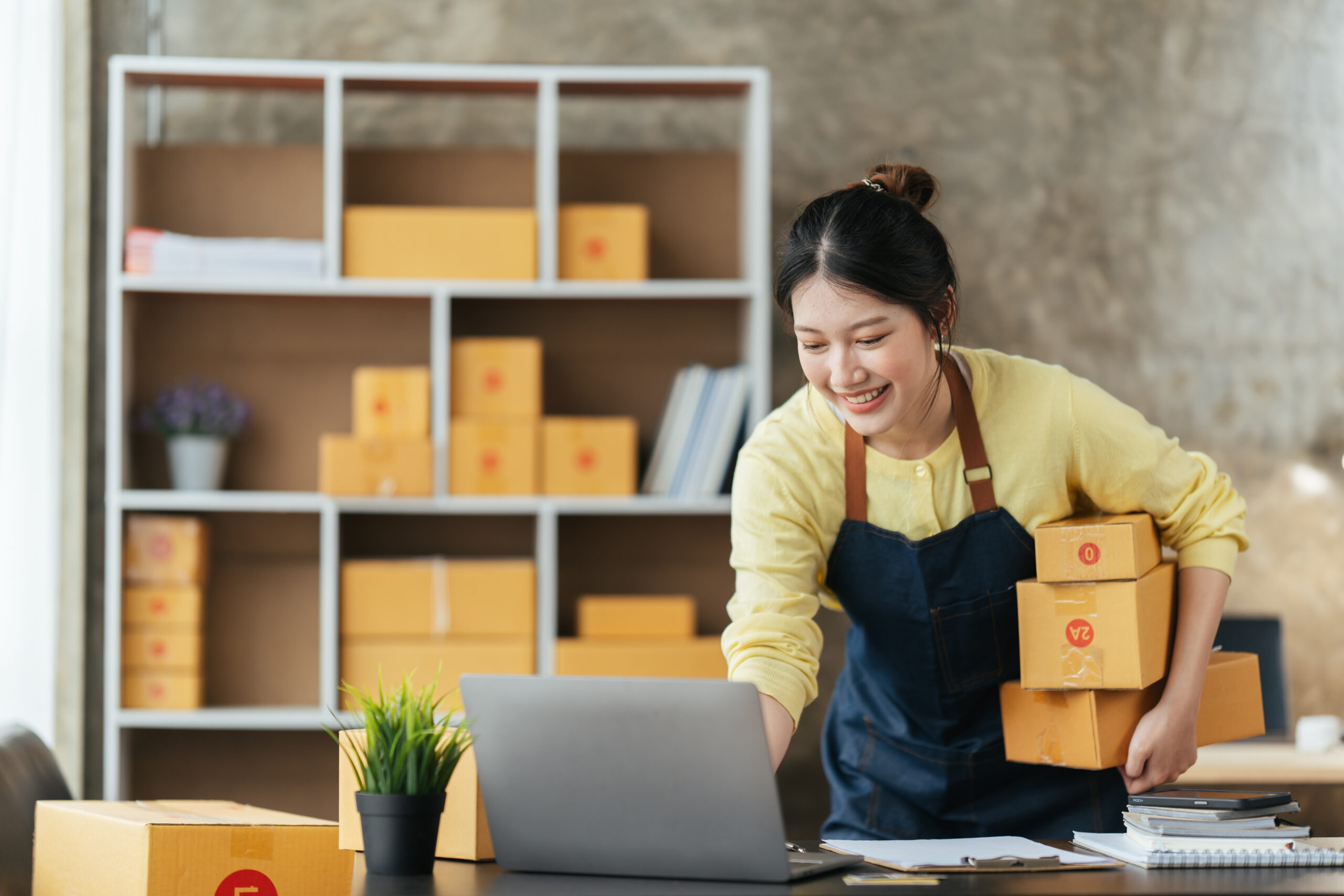 young female owner startup business work happy with box