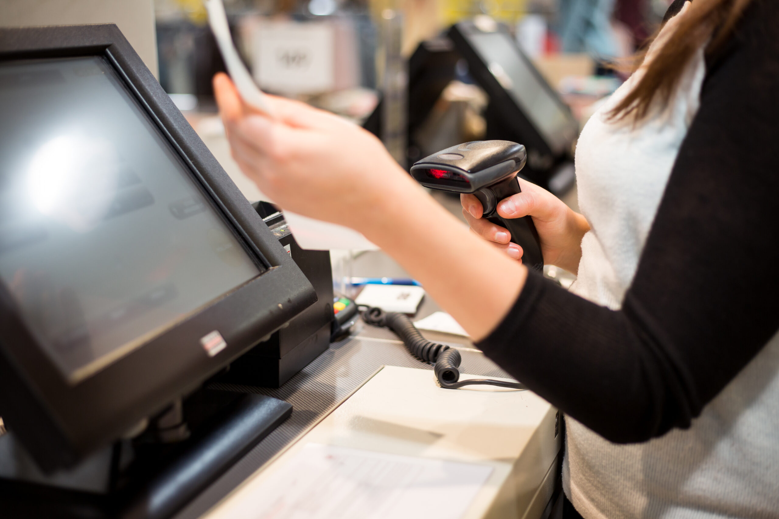 Young woman hand doing process payment on a touchscreen cash register