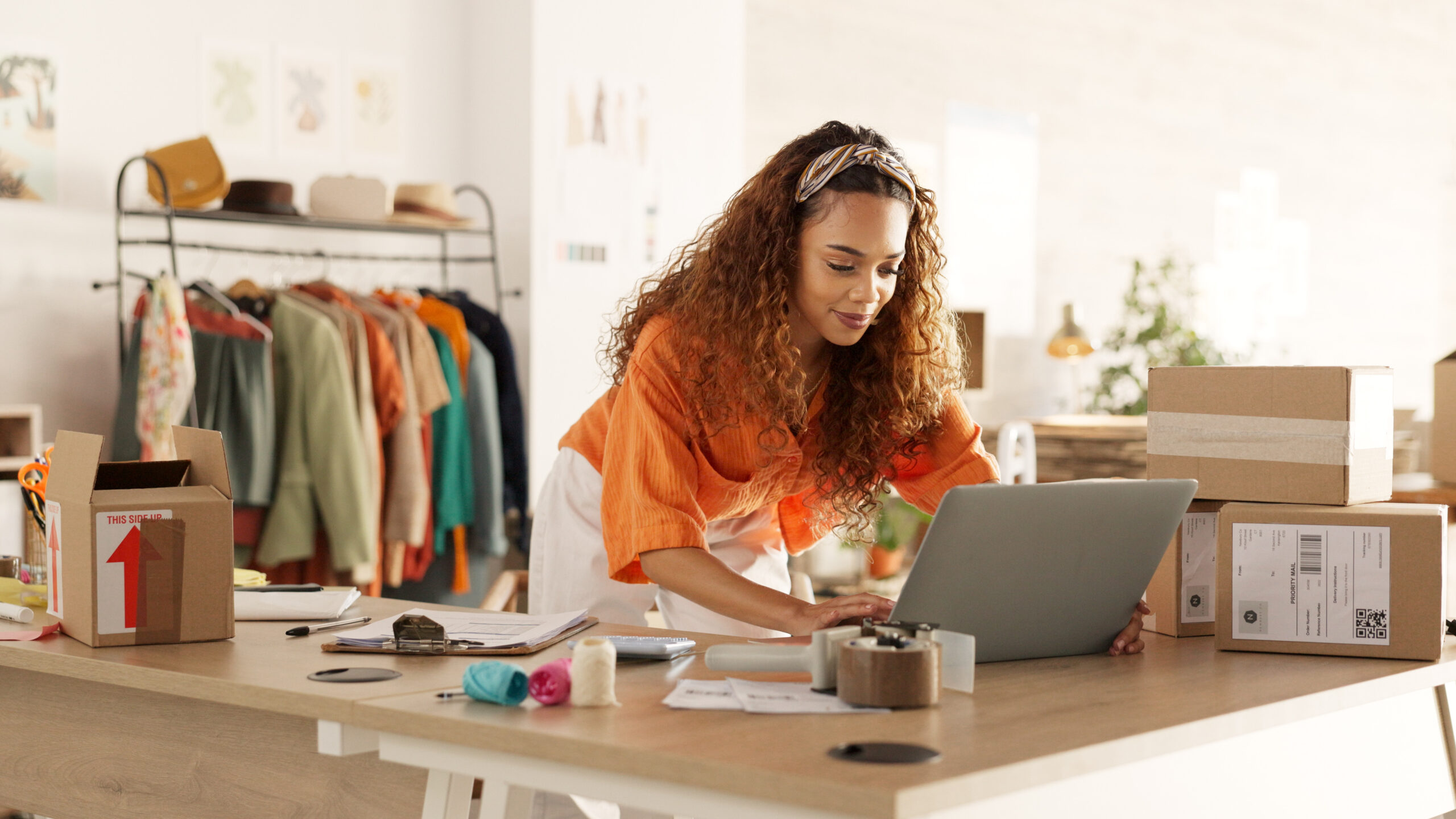 laptop and fashion manager of retail or boutique shop checking clothing stock