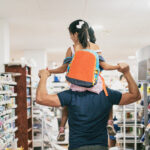 Father and daughter buying school supplies