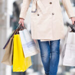 woman walking with shopping bags with christmas background.
