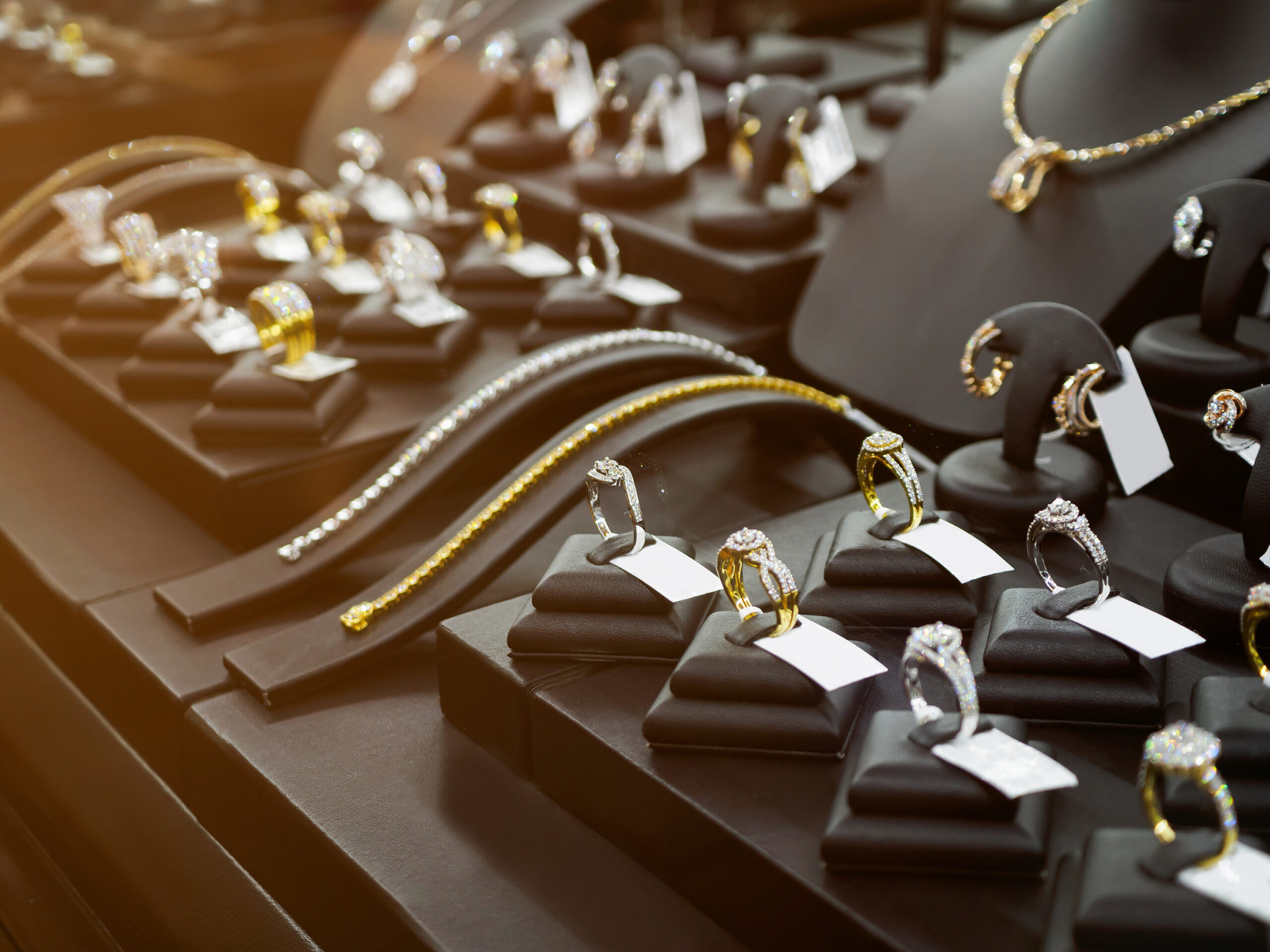 Gold jewelry diamond shop with rings and necklaces luxury retail store window display showcase