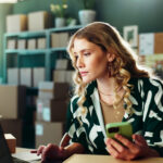 woman with laptop at small business for inventory management or compare invoice.