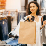 Portrait of a girl with paper bags in clothing store