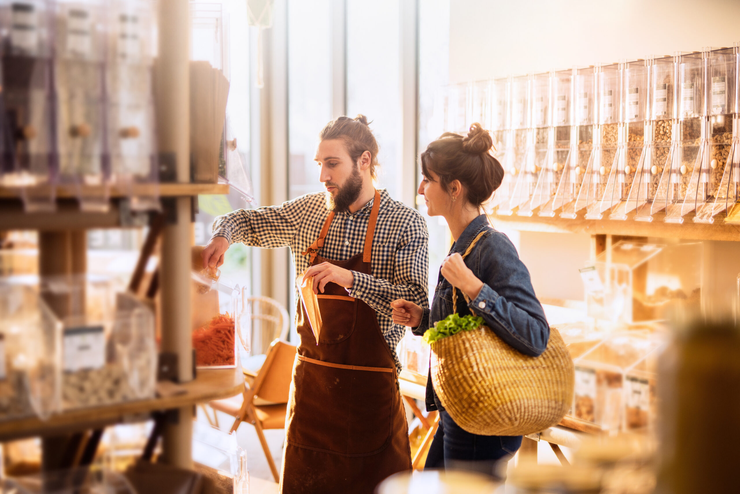 young woman shopping in a bulk food store.