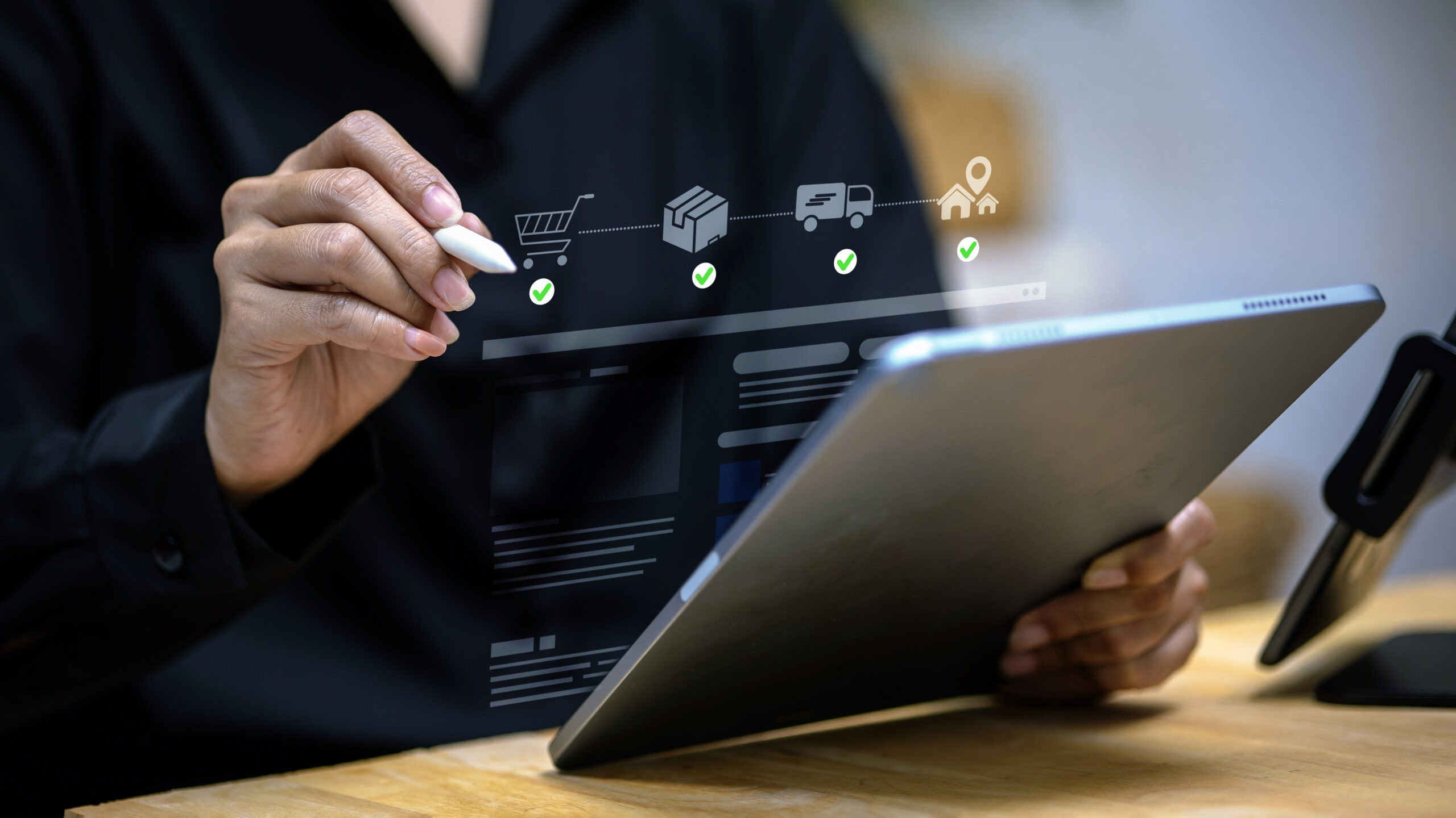 Person using tablet with digital e-commerce workflow including shopping cart, packaging, delivery, and home icons