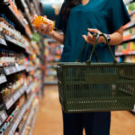 shopper choosing a healthy product while grocery shopping in a supermarket aisle