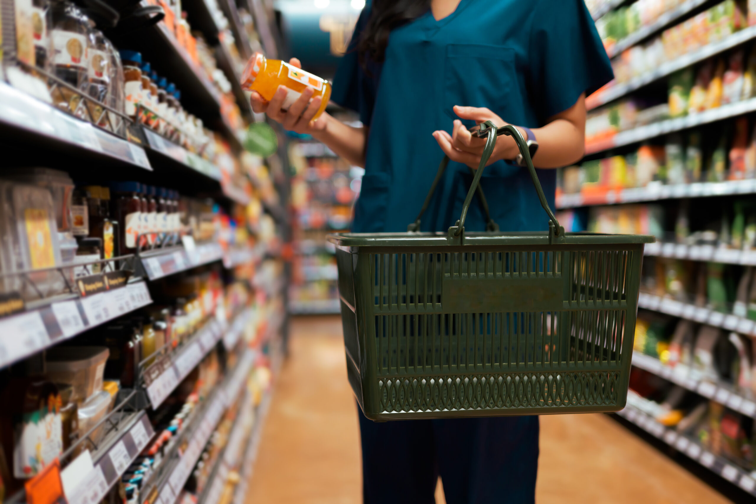 shopper choosing a healthy product while grocery shopping in a supermarket aisle