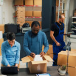 Employees putting products in boxes