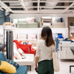 Young woman choosing furniture in a modern home furnishings store
