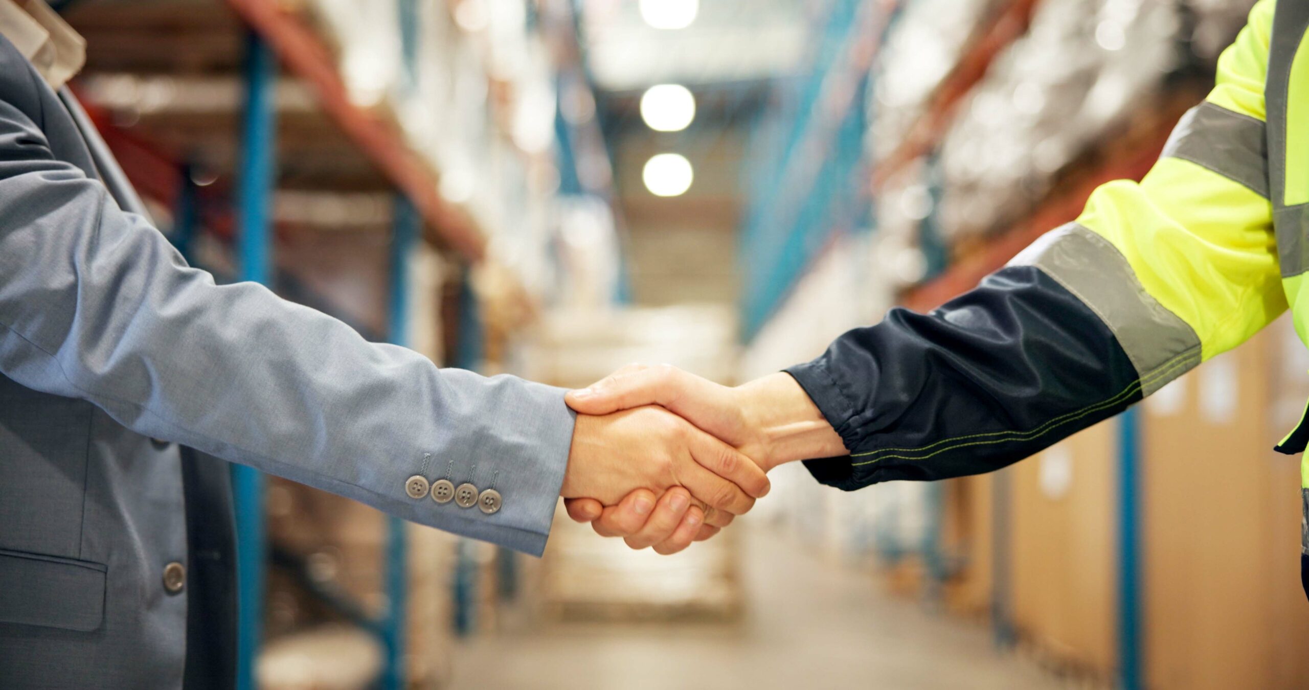 Business people handshake in warehouse
