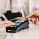 Close up of old man paying with credit card on pos terminal.