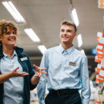 grocery store manager training new male employee.