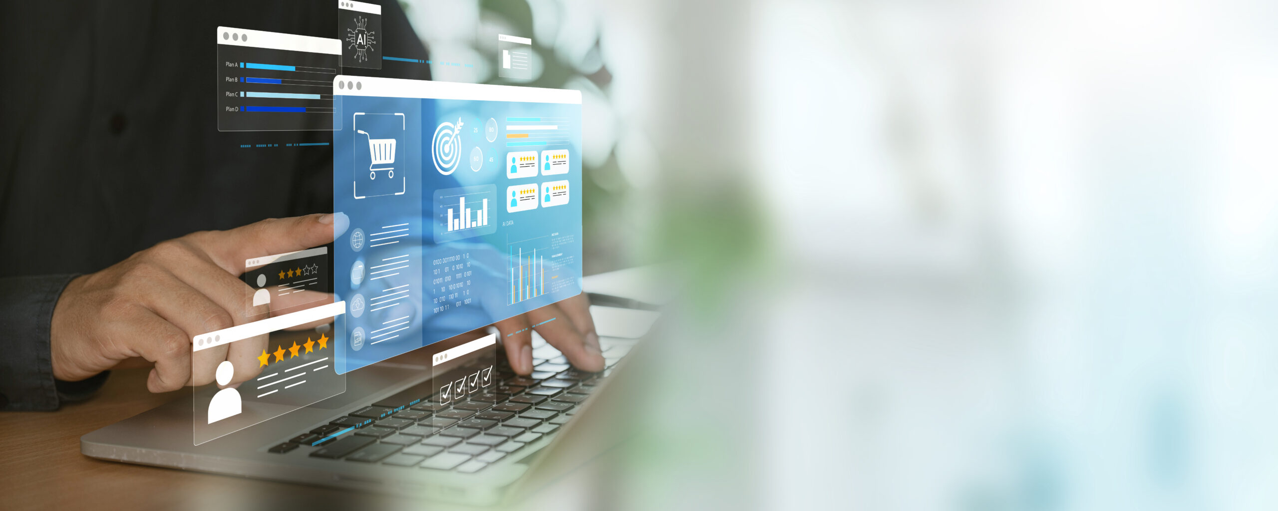 A person interacts with a laptop displaying digital shopping analytics
