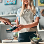 Cropped image of customer paying using smart phone.