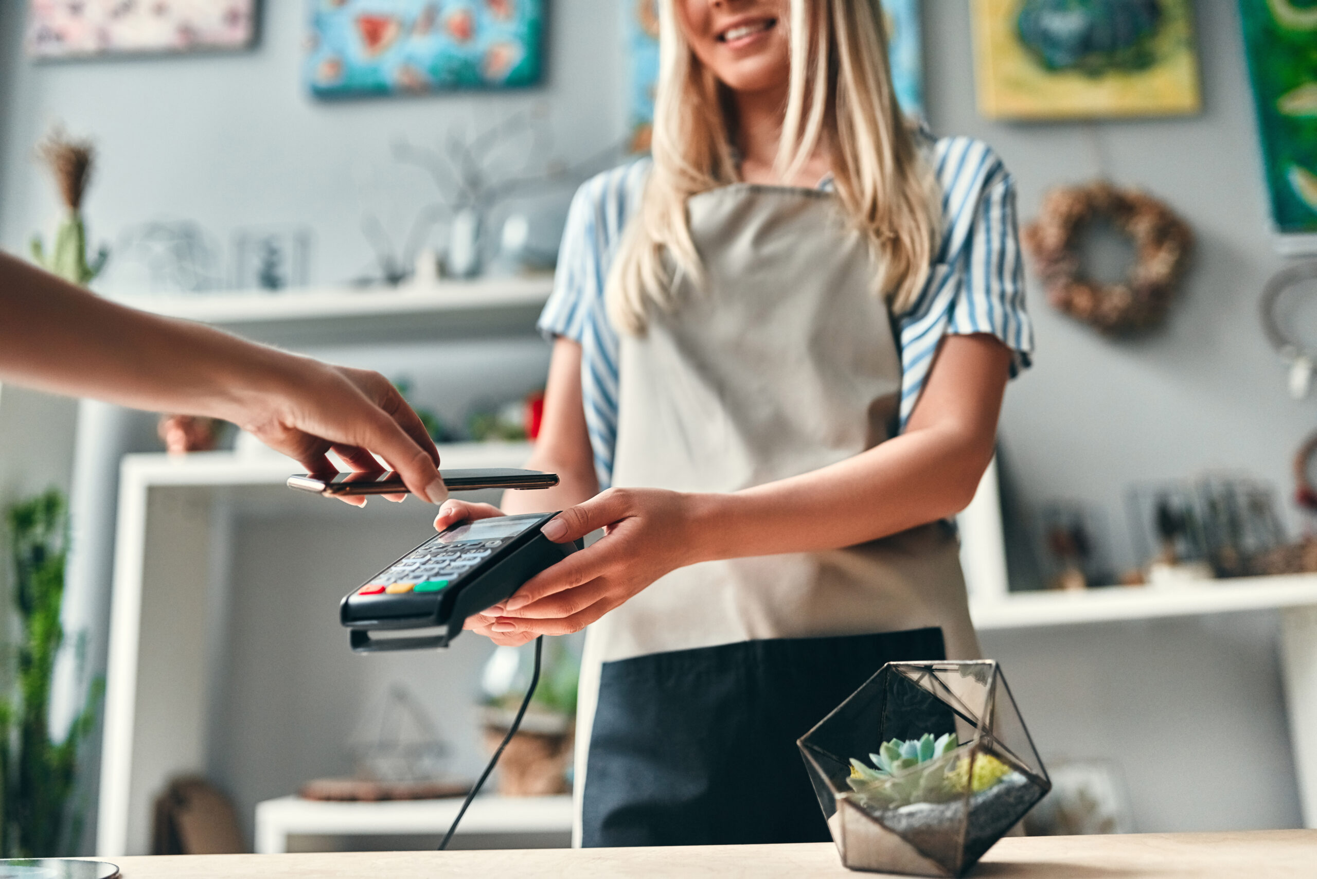 Cropped image of customer paying using smart phone.